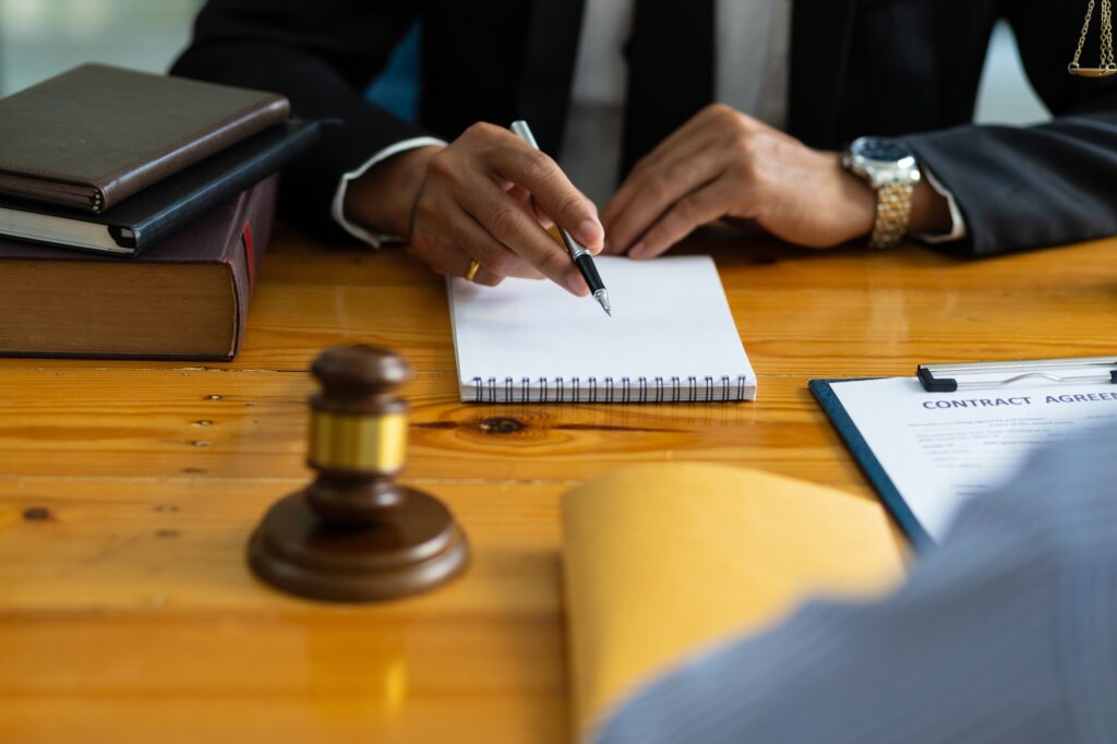 Legal consulting services, legal negotiations, Lawyer are signing legal contract agreement document.